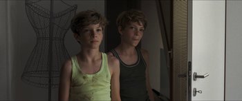 Movie still from “Goodnight Mommy” (2014), directed by Severin Fiala – Two young boys standing next to each other in front of a mirror; Close Up shot, High angle