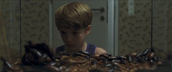Movie still from “Goodnight Mommy” (2014), directed by Severin Fiala – A young boy looking at a pile of dirt; Close Up shot, High angle