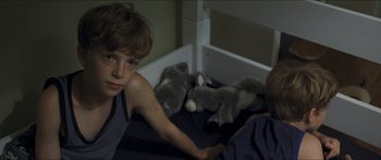 Movie still from “Goodnight Mommy” (2014), directed by Severin Fiala – Two boys sitting on a bed next to stuffed animals; Close Up shot, High angle