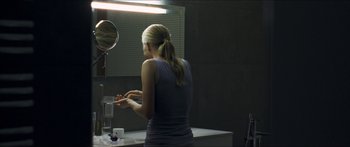Movie still from “Goodnight Mommy” (2014), directed by Severin Fiala – A woman in a bathroom putting lotion on her hands; Medium shot, Over the shoulder angle