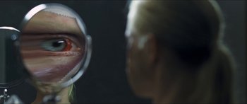 Movie still from “Goodnight Mommy” (2014), directed by Severin Fiala – A woman looking at her reflection in a mirror; Extreme Close Up shot, Over the shoulder angle