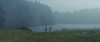 Movie still from “Goodnight Mommy” (2014), directed by Severin Fiala – Two people are playing frisbee on a foggy day; Extreme Wide shot, High angle