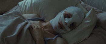 Movie still from “Goodnight Mommy” (2014), directed by Severin Fiala – A woman with a bandage wrapped around her face; Close Up shot, High angle