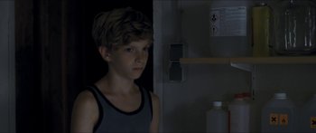Movie still from “Goodnight Mommy” (2014), directed by Severin Fiala – A young boy standing next to a refrigerator; Close Up shot, Over the shoulder angle