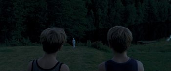 Movie still from “Goodnight Mommy” (2014), directed by Severin Fiala – Two young boys looking at a statue in the middle of the night; Extreme Wide shot, Over the shoulder angle