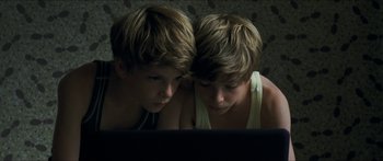 Movie still from “Goodnight Mommy” (2014), directed by Severin Fiala – Two young boys looking at a computer screen; Close Up shot, Overhead angle
