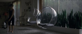 Movie still from “Goodnight Mommy” (2014), directed by Severin Fiala – A cat sitting on a chair in front of a window; Wide shot, High angle