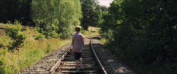 Movie still from “Goodnight Mommy” (2014), directed by Severin Fiala – A boy is walking on the railroad tracks; Wide shot, High angle