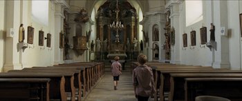 Movie still from “Goodnight Mommy” (2014), directed by Severin Fiala – Two people walking down the aisle of a church; Wide shot, Low angle