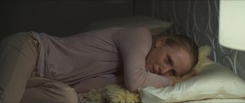 Movie still from “Goodnight Mommy” (2014), directed by Severin Fiala – A woman laying in bed with her head on a pillow; Close Up shot, Overhead angle