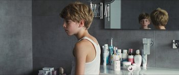 Movie still from “Goodnight Mommy” (2014), directed by Severin Fiala – A young boy in a white tank top in front of a bathroom mirror; Close Up shot, Over the shoulder angle