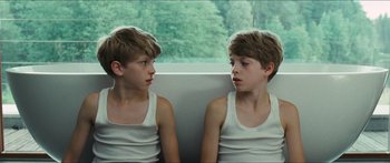 Movie still from “Goodnight Mommy” (2014), directed by Severin Fiala – Two young boys sitting next to each other in front of a window; Close Up shot, High angle