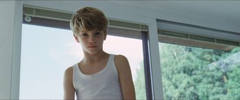 Movie still from “Goodnight Mommy” (2014), directed by Severin Fiala – A boy in a white tank top looking at the camera; Close Up shot, Low angle