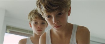 Movie still from “Goodnight Mommy” (2014), directed by Severin Fiala – Two young boys looking at each other in the mirror; Close Up shot, High angle