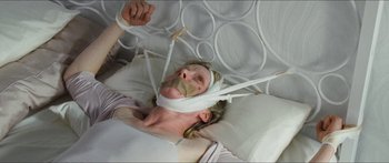 Movie still from “Goodnight Mommy” (2014), directed by Severin Fiala – A woman laying in a bed with a bandage on her face; Close Up shot, High angle