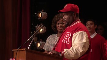 Movie still from “Grease Live!” (2016), directed by Thomas Kail – A man and a woman standing in front of a microphone; Close Up shot, Over the shoulder angle