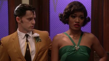 Movie still from “Grease Live!” (2016), directed by Thomas Kail – A man and a woman standing next to each other in front of a purple wall; Close Up shot, Over the shoulder angle