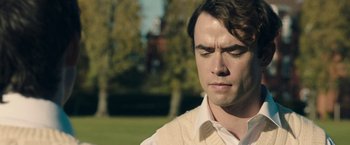 Movie still from “Greed” (2019), directed by Michael Winterbottom – A person with his eyes closed; Close Up shot, Over the shoulder angle