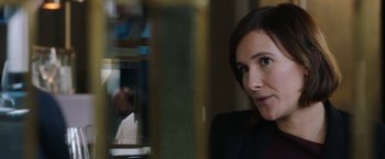 Movie still from “Greed” (2019), directed by Michael Winterbottom – A person in a suit; Close Up shot, Over the shoulder angle