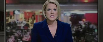 Movie still from “Greed” (2019), directed by Michael Winterbottom – A woman with blonde hair is wearing a blue suit; Close Up shot, Low angle