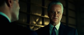Movie still from “Green Lantern” (2011), directed by Martin Campbell – An older man in a suit and blue tie; Close Up shot, Over the shoulder angle