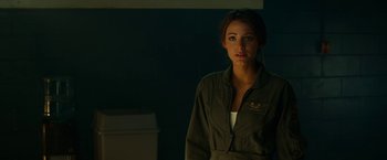 Movie still from “Green Lantern” (2011), directed by Martin Campbell – A woman standing in the dark wearing a uniform; Close Up shot, Over the shoulder angle