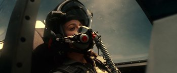 Movie still from “Green Lantern” (2011), directed by Martin Campbell – A woman in a fighter pilot's helmet and mask; Close Up shot, Low angle