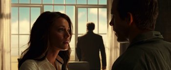 Movie still from “Green Lantern” (2011), directed by Martin Campbell – A woman and a man standing in front of a window; Close Up shot, Over the shoulder angle