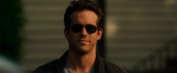 Movie still from “Green Lantern” (2011), directed by Martin Campbell – A person wearing sunglasses; Close Up shot, Low angle