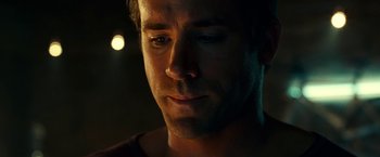 Movie still from “Green Lantern” (2011), directed by Martin Campbell – A man's face in the dark; Close Up shot, Over the shoulder angle