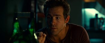 Movie still from “Green Lantern” (2011), directed by Martin Campbell – A person holding a cell phone; Close Up shot, Over the shoulder angle