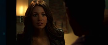 Movie still from “Green Lantern” (2011), directed by Martin Campbell – A beautiful young woman with long brown hair and green eyes; Close Up shot, Over the shoulder angle
