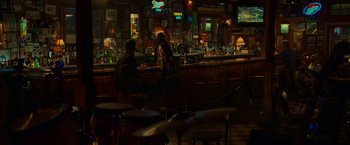 Movie still from “Green Lantern” (2011), directed by Martin Campbell – Two people are sitting at a bar at night; Wide shot, Over the shoulder angle