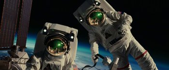 Movie still from “Green Lantern” (2011), directed by Martin Campbell – Two astronauts in spacesuits are in front of the earth; Wide shot, Overhead angle