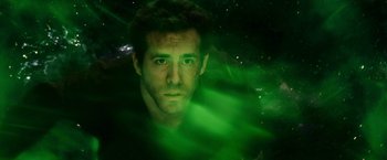 Movie still from “Green Lantern” (2011), directed by Martin Campbell – A man with a green light behind him; Close Up shot, Overhead angle
