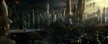 Movie still from “Green Lantern” (2011), directed by Martin Campbell – A man in a green suit standing in front of a city; Extreme Wide shot, High angle