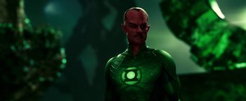 Movie still from “Green Lantern” (2011), directed by Martin Campbell – A man in a green suit with a green lantern on his chest; Medium shot, Low angle