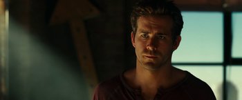 Movie still from “Green Lantern” (2011), directed by Martin Campbell – A person wearing a red shirt; Close Up shot, Over the shoulder angle