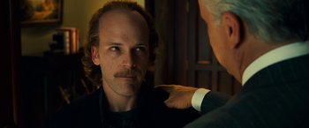 Movie still from “Green Lantern” (2011), directed by Martin Campbell – A person wearing a suit and tie; Close Up shot, Over the shoulder angle