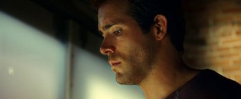 Movie still from “Green Lantern” (2011), directed by Martin Campbell – A man's face in the dark; Close Up shot, Low angle