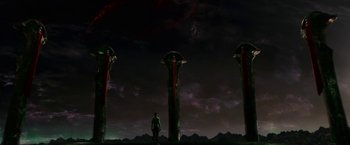 Movie still from “Green Lantern” (2011), directed by Martin Campbell – A man standing in front of three tall pillars; Extreme Wide shot, Low angle