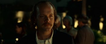 Movie still from “Green Lantern” (2011), directed by Martin Campbell – A man with long hair and a mustache; Close Up shot, Over the shoulder angle