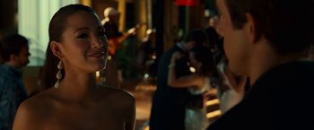 Movie still from “Green Lantern” (2011), directed by Martin Campbell – A woman standing next to a crowd of people in a room; Close Up shot, Over the shoulder angle