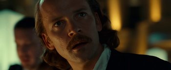 Movie still from “Green Lantern” (2011), directed by Martin Campbell – A person wearing a suit and tie; Close Up shot, Low angle