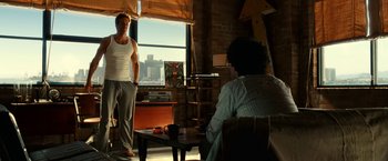 Movie still from “Green Lantern” (2011), directed by Martin Campbell – A man standing in front of another man sitting in front of a window; Wide shot, Over the shoulder angle