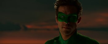 Movie still from “Green Lantern” (2011), directed by Martin Campbell – A person wearing a green mask; Close Up shot, Over the shoulder angle