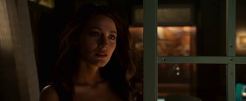 Movie still from “Green Lantern” (2011), directed by Martin Campbell – A beautiful young woman with long brown wavy hair; Close Up shot, Over the shoulder angle