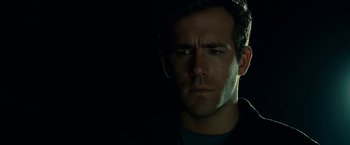 Movie still from “Green Lantern” (2011), directed by Martin Campbell – A person in a dark room; Close Up shot, Low angle