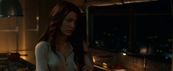 Movie still from “Green Lantern” (2011), directed by Martin Campbell – A beautiful woman standing in a dark room; Close Up shot, Over the shoulder angle