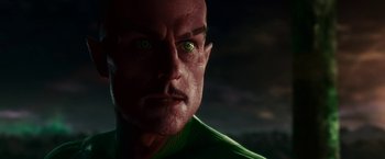 Movie still from “Green Lantern” (2011), directed by Martin Campbell – A man's face with green eyes; Close Up shot, Low angle
